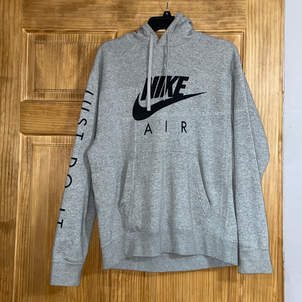 Gray Nike air hoodie. Says “just do it” on the sleeve